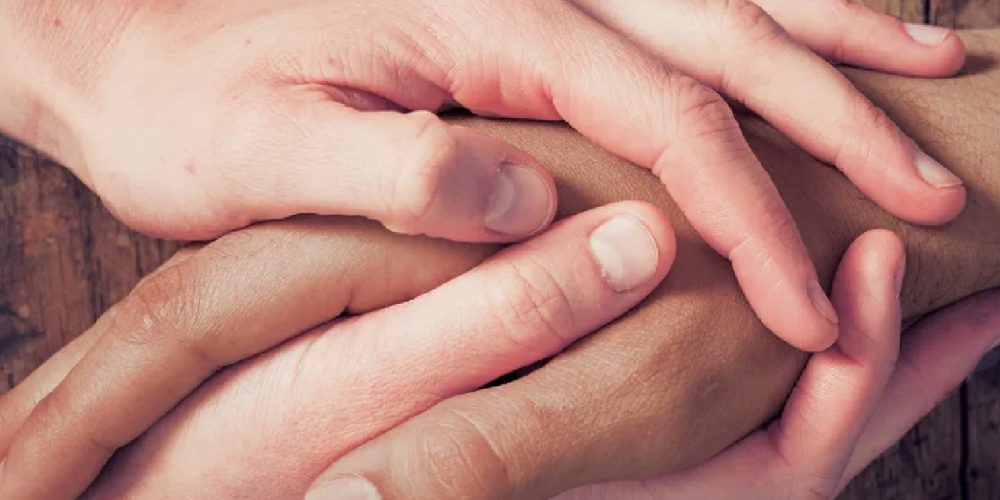 hands holding in a consoling way