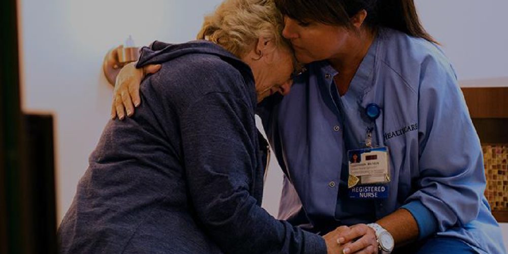 nurse consoling a patient