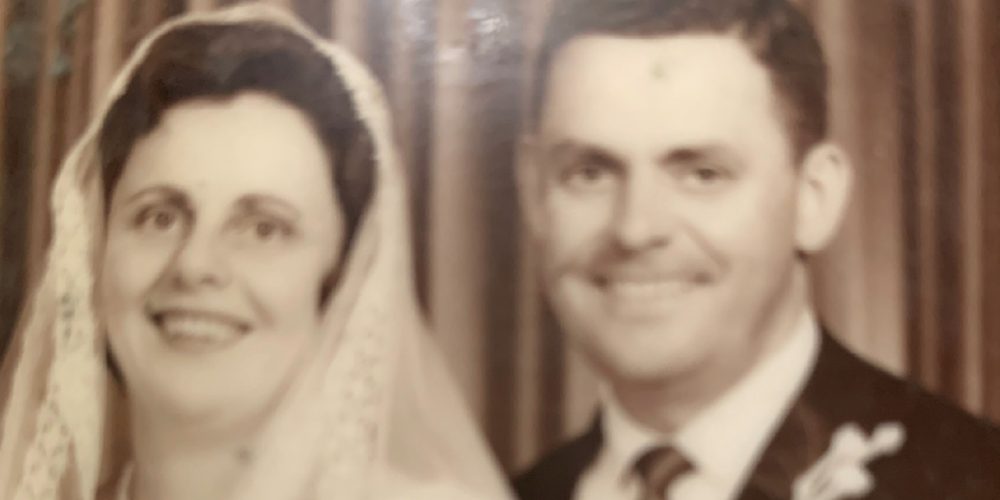 an old family photo of a young couple on their wedding day