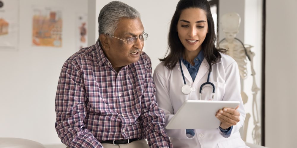 doctor speaking with an elderly patient