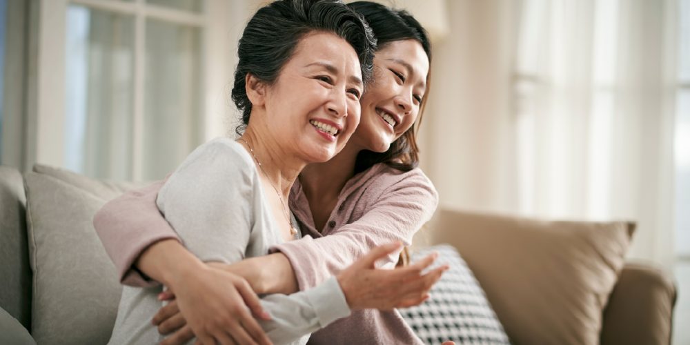 woman hugging a family member receiving palliative care