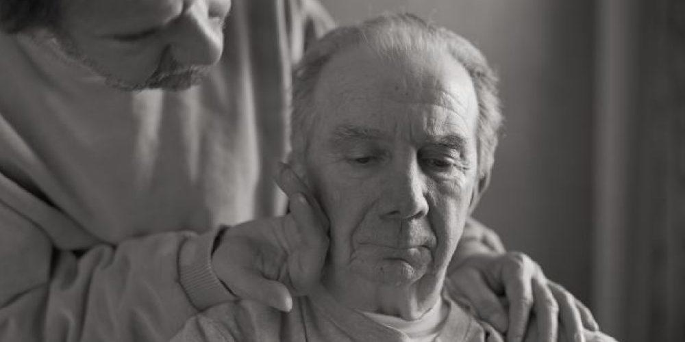caring family member consoling a dementia patient